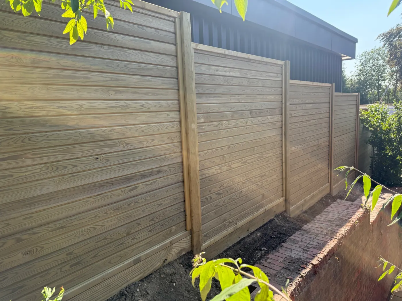 Horizontal tongue and groove fence panels installed