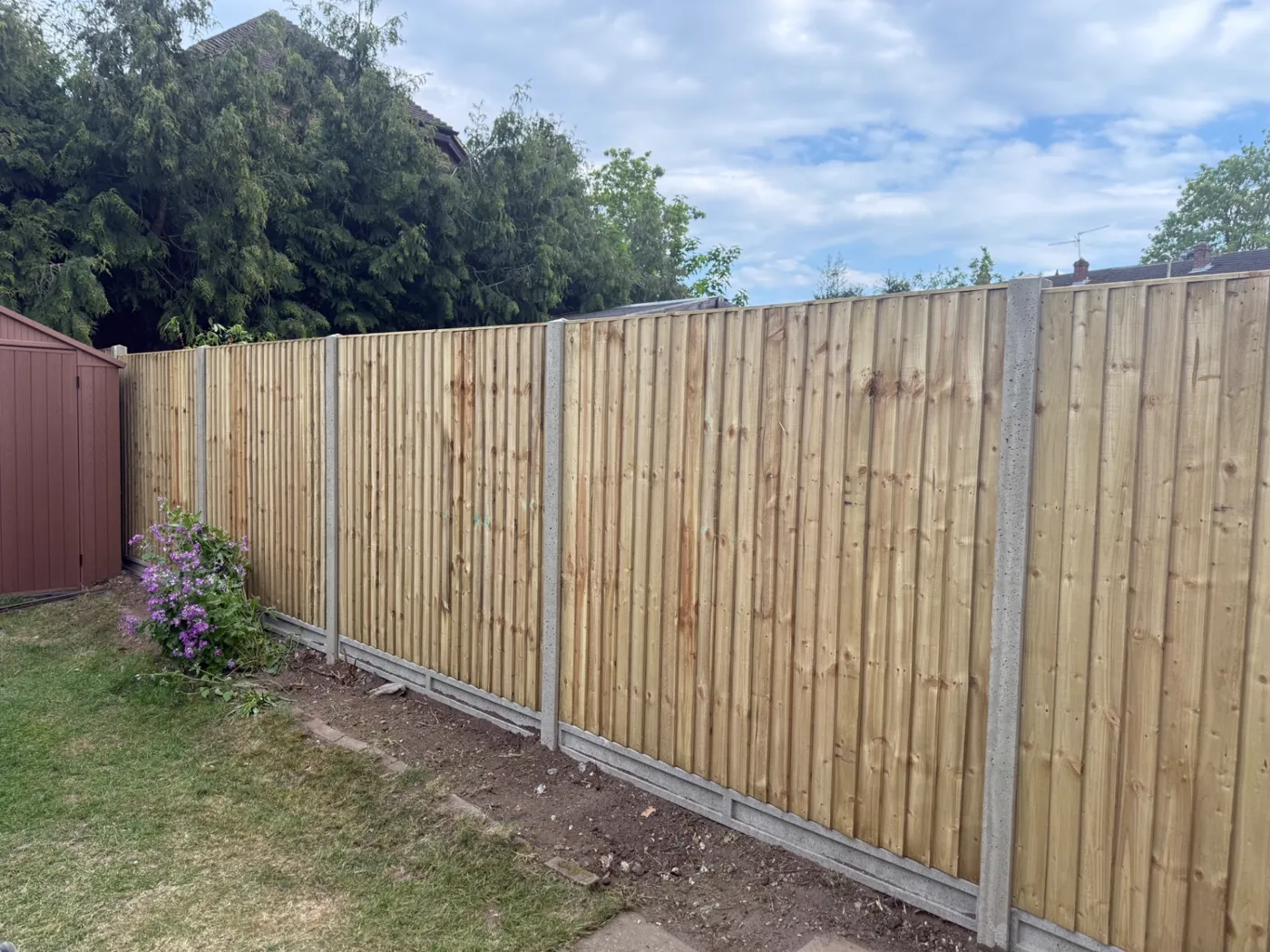 Closeboard fence panels and gravel boards replacing an old garden boundary