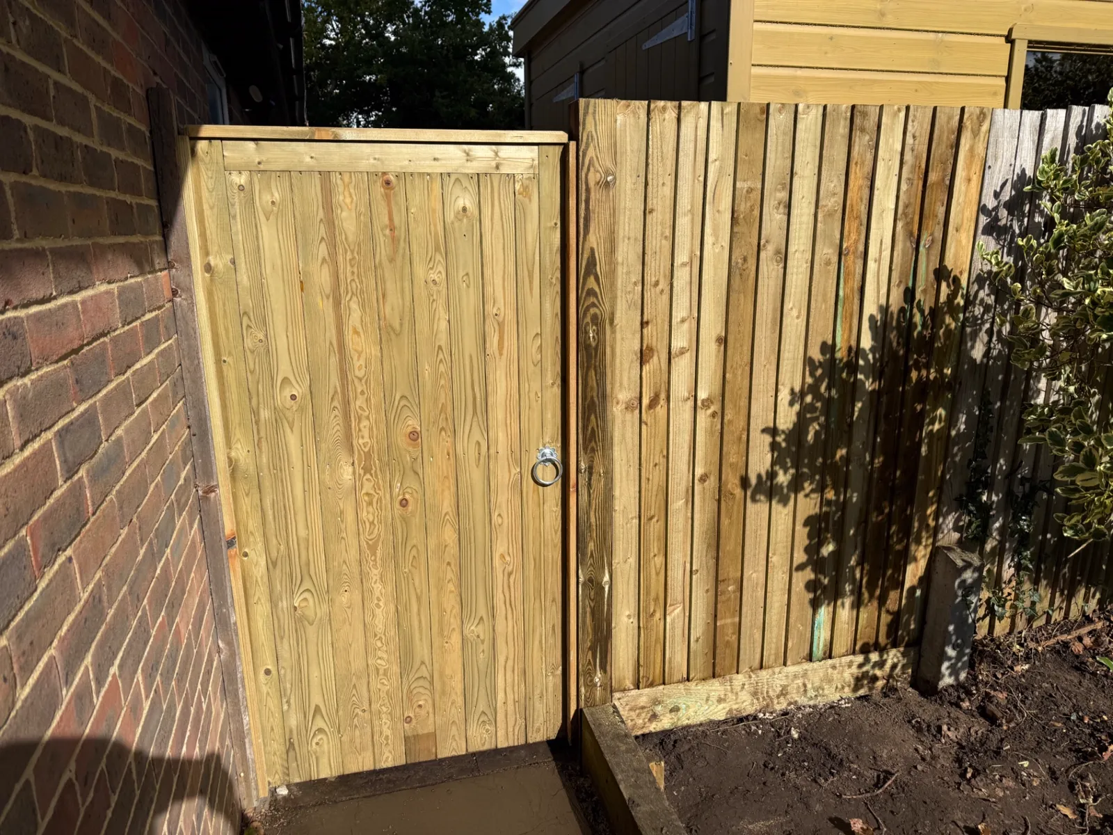 New tongue and groove side gate fitted beside a house